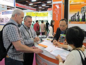 Tucker Rocky execs Charlie Hadayia, Jr. (left) and Brian Berney listen to a vendor presentation in Taipei.