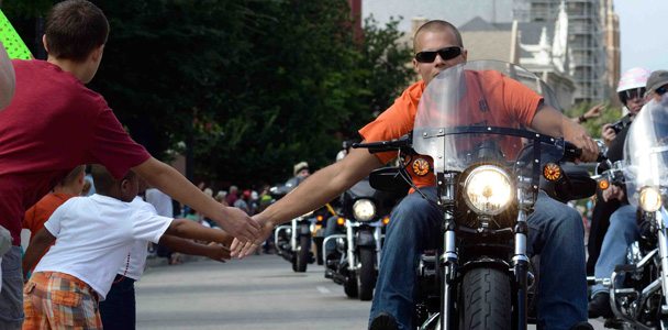Tens of thousands of local fans line the streets of Milwaukee as nearly 7,000 Harley-Davidson riders paraded about five miles through the downtown streets.