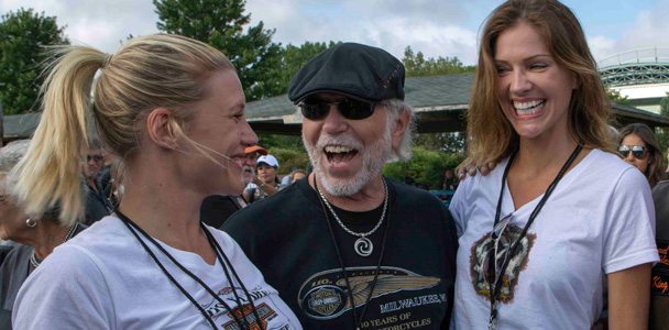 Pictured from left to right, actress Katee Sackhoff (co-star of the upcoming feature film “Riddick”), Willie G. Davidson (grandson of Harley-Davidson co-founder William A. Davidson) and actress Tricia Helfer (co-star of ABC's “Killer Women”) share a laugh before the start of the Harley-Davidson 110th Anniversary parade in Milwaukee.