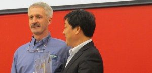 Tracey Harmon from Alaska Power Sports accepts his No. 1 dealer trophy from Mr. Lai, president and chairman of CFMOTO.